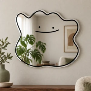 Smile blob acrylic wall mirror with a black smiling face and irregular outline on a warm neutral wall.