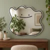 02-smile-mirror-lifestyle Ready-made smile blob mirror styled on a sage wall with warm wood furniture.