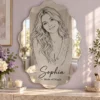 sophia-magic-scalloped-01-main Sophia Made of Magic personalized scalloped-oval portrait acrylic mirror with black line art in a lilac and ivory vanity setting.